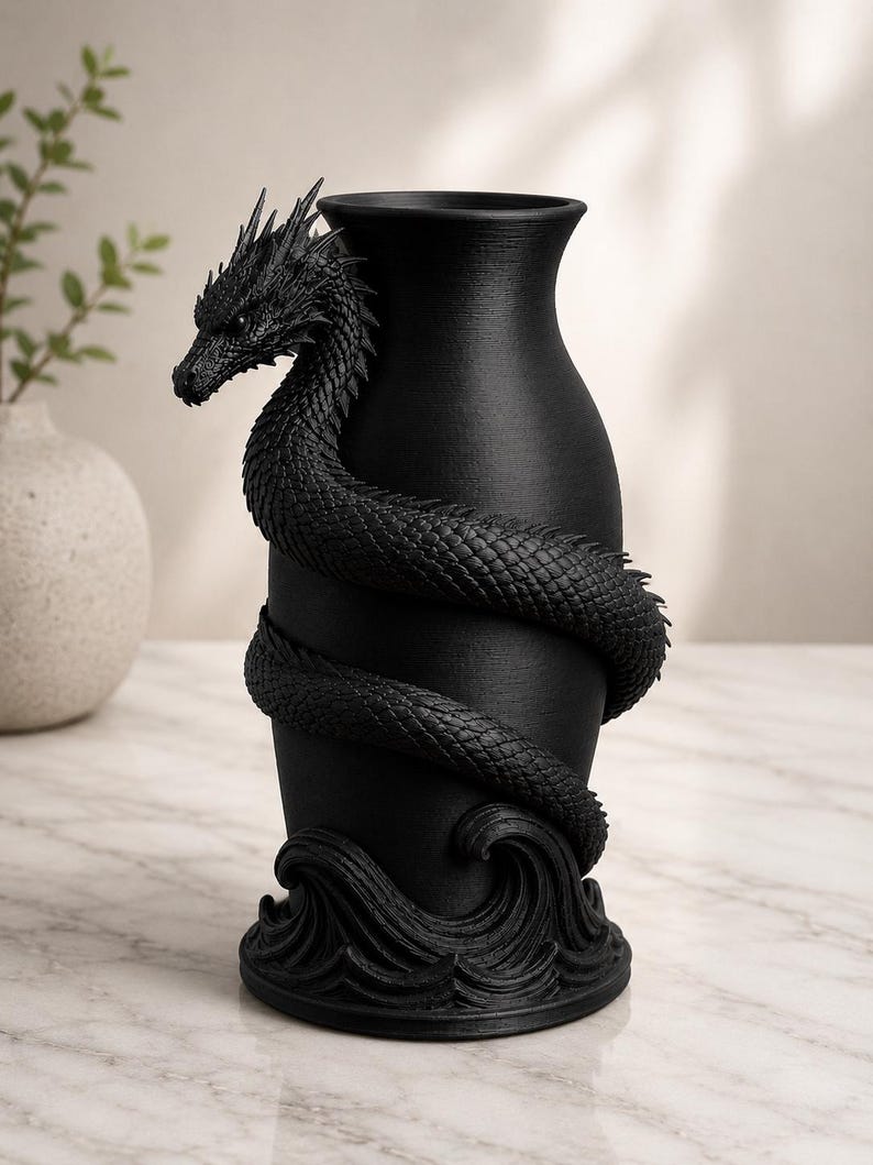 May include: Black vase with a dragon wrapped around the body. The dragon has detailed scales and a fierce expression. The base of the vase features a wave design. The vase is a decorative home decor item.