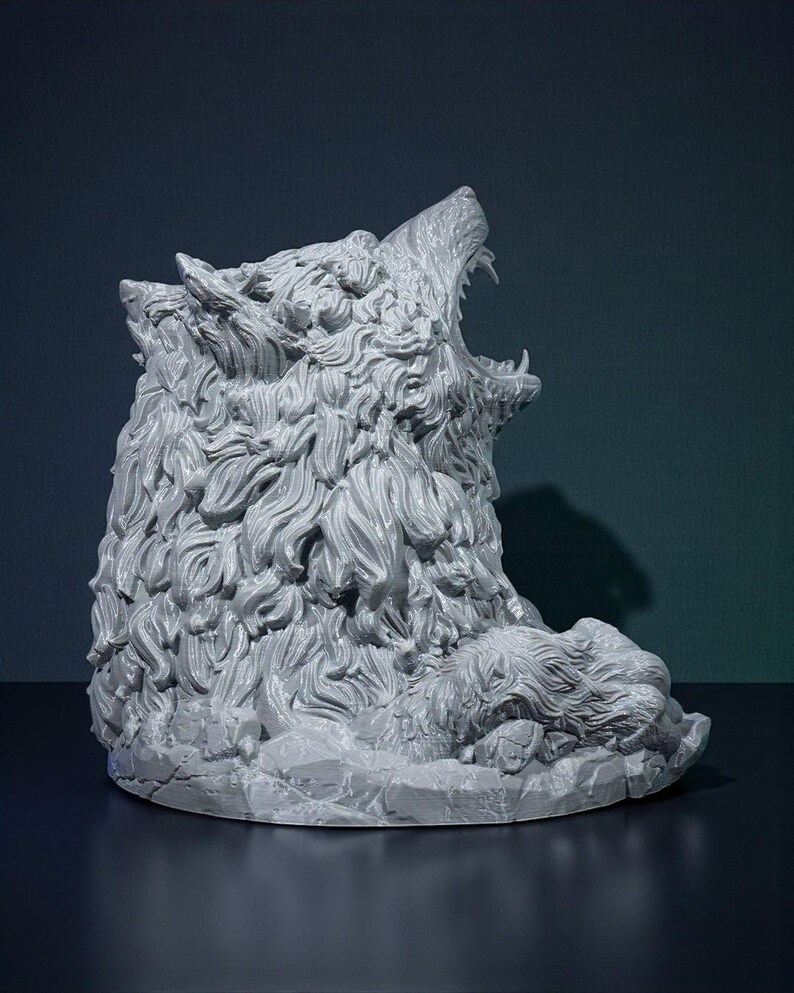 May include: A gray sculpture of a wolf's head, with its mouth open in a roar. The sculpture has detailed fur and sits on a rocky base. The background is a dark teal color.