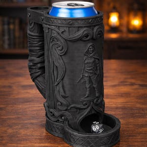 May include: Black, intricately carved beer stein with a blue can inside. The stein features a detailed relief of a hooded figure and a dice tray. The design includes floral and wood-like textures, perfect for tabletop gaming.