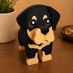 May include: A wooden Rottweiler dog figurine with black and tan coloring. The dog has large, expressive eyes and a detailed design. The figurine is standing on a wooden surface, showcasing its three-dimensional form. A decorative item for dog lovers.