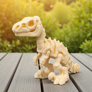 May include: A cream-colored dinosaur skeleton toy, featuring articulated joints and a detailed skeletal structure. The toy is posed on a gray wooden surface, with a blurred green background of foliage. The dinosaur's head is turned to the left.