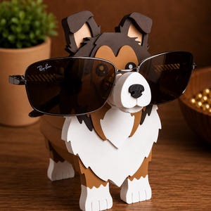 May include: A wooden dog-shaped eyeglass holder with a white, brown, and black color scheme. The dog is wearing a pair of Ray-Ban sunglasses. The holder is on a wooden surface.