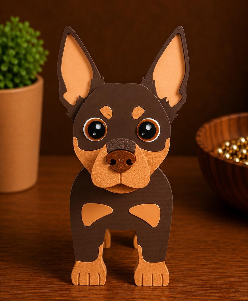 May include: A handcrafted paper dog sculpture in brown and tan. The dog has large, expressive eyes, a tan snout, and tan-colored ears. The sculpture is standing upright, showcasing its detailed design and craftsmanship. A charming decorative item.