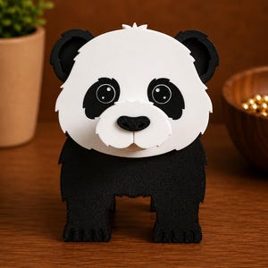 May include: A black and white panda bear figurine. The panda has a white face with black eye patches, ears, and a black nose. The panda is standing on all fours. The figurine is made of a textured material.
