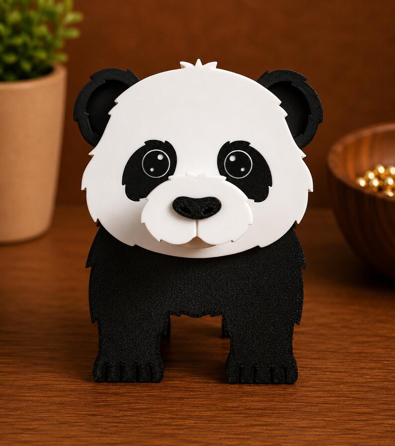 May include: A black and white panda bear figurine. The panda has a white face with black eye patches, ears, and a black nose. The panda is standing on all fours. The figurine is made of a textured material.