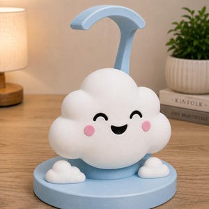 May include: A whimsical cloud-shaped night light in white and light blue. The cloud has a smiling face with pink cheeks and sits on a round base. A curved light arm extends from the base. The lamp is designed for a child's room.