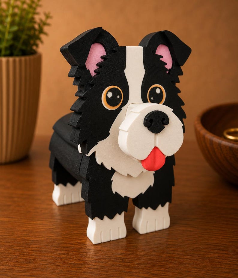 May include: A wooden dog sculpture in black, white, and pink. The dog has large, round eyes, a red tongue, and a white muzzle. The sculpture is made of layered wood pieces and has a playful, cartoonish appearance.