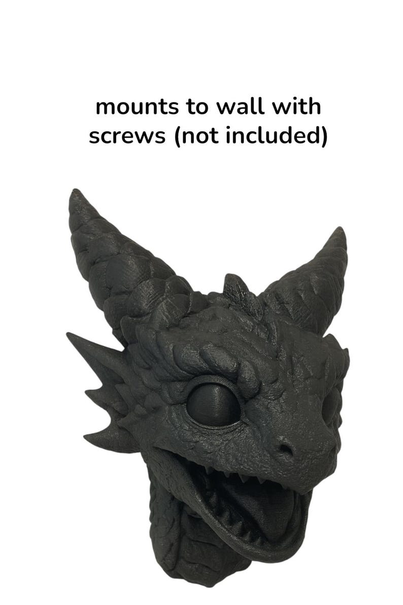 May include: A black dragon head sculpture with textured details, featuring horns, sharp teeth, and a detailed eye. The text "mounts to wall with screws (not included)" is above the dragon head.