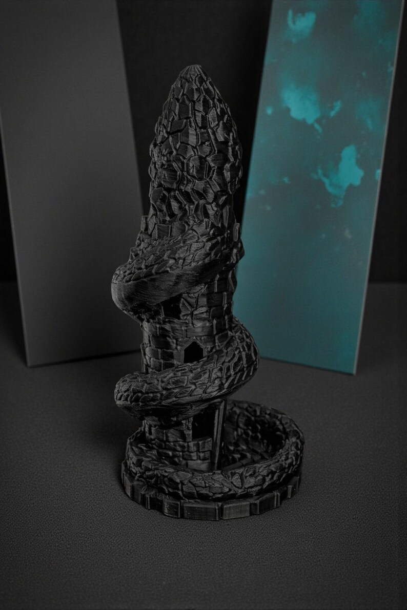 May include: A black, 3D-printed sculpture of a tower entwined by a snake. The tower has a textured, stone-like appearance with a spiraling snake wrapped around it. The sculpture is set against a dark background.