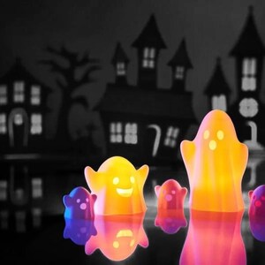 May include: A group of five glowing ghost-shaped Halloween decorations in front of a black and white silhouette of a haunted house. The ghosts are yellow, orange, and purple.