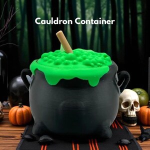 May include: A black cauldron container with a green, bubbling substance overflowing from the top. A wooden stick is inserted into the green liquid. The text "Cauldron Container" is displayed on the image. The cauldron is a Halloween-themed decoration.