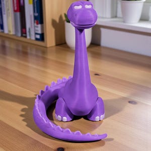May include: A purple dinosaur figurine with a long neck and tail, and white accents on its eyes and feet. The figurine is made of a 3D-printed material and sits on a wooden surface. The dinosaur has a friendly, cartoonish appearance.