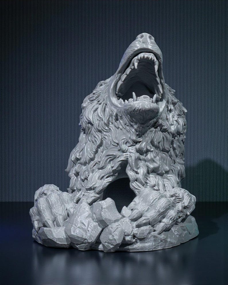 May include: A gray sculpture of a bear with its mouth wide open, revealing sharp teeth. The bear's fur is detailed, and it sits atop a base of stylized rocks. The sculpture is a detailed representation of a roaring bear.