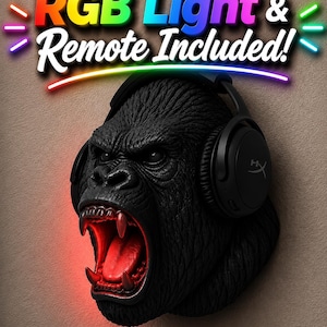 May include: A black gorilla head sculpture with red glowing mouth and teeth, wearing black headphones. The text "RGB Light & Remote Included!" is above the gorilla's head in colorful letters.