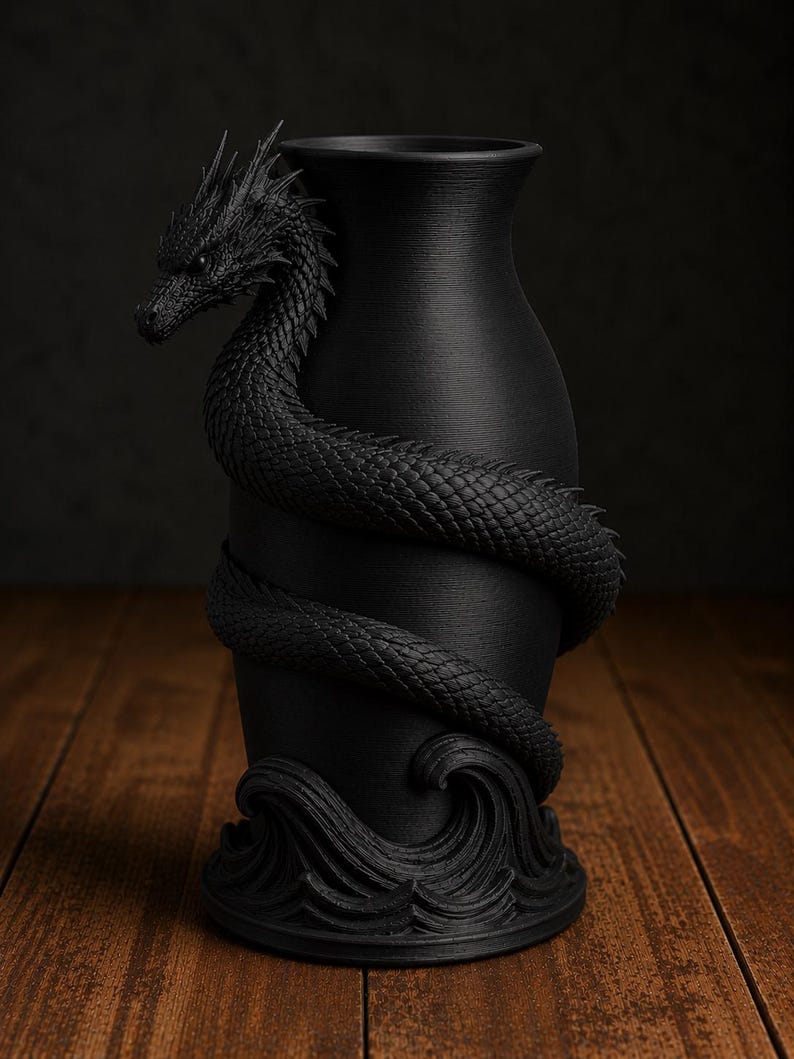 May include: A black vase with a dragon wrapped around it. The dragon's head is at the top, and its body coils around the vase. The base of the vase features a wave design. The vase is made of a matte black material.