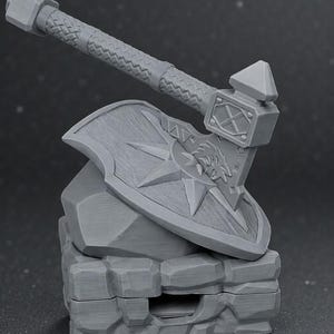 May include: A gray miniature axe and shield set, resting on a stone-like base. The axe features a textured handle and a detailed head. The shield displays a star and a wolf's head. This item is likely a collectible or decorative piece.