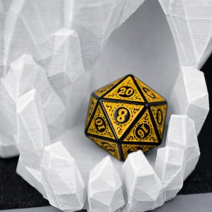 May include: A yellow and black twenty-sided die, with numbers and decorative patterns, rests inside a white, geometric, crystalline structure. The die is the focal point, showcasing its intricate design and the contrast between the colors.
