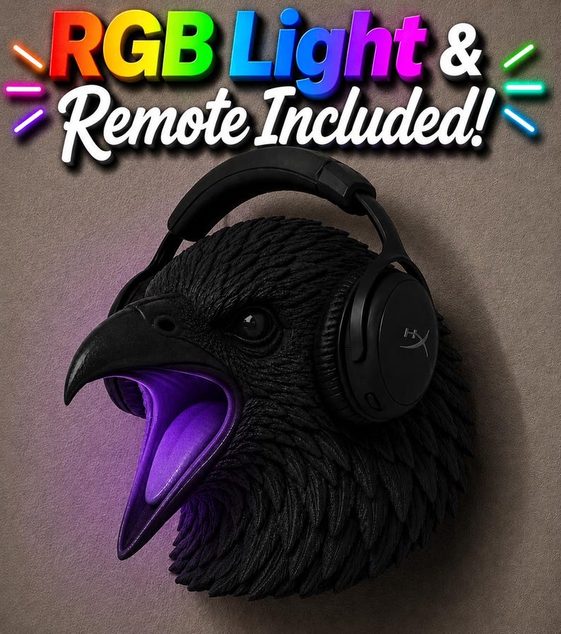May include: A black raven head sculpture with an open beak, lit with purple light. The raven wears black headphones. The text "RGB Light & Remote Included!" is displayed above the raven's head.