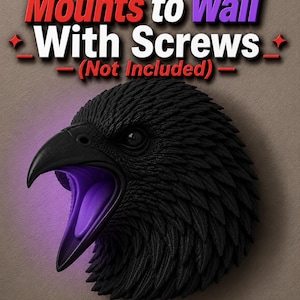 May include: A black raven head sculpture with an open beak, illuminated with purple light. The sculpture is designed to mount to a wall. The text "Mounts to Wall With Screws (Not Included)" is displayed above the raven.