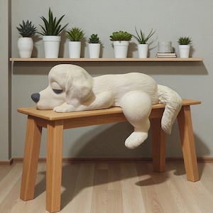 May include: A large, cream-colored dog sculpture rests on a light brown wooden bench. The dog has a blue nose and closed eyes, appearing relaxed. A shelf above holds several potted plants. The bench is approximately 36 inches long.