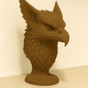 May include: A detailed brown sculpture of a griffin's head. The mythical creature has a sharp beak, intense gaze, and feathered details. The sculpture is mounted on a pedestal, showcasing the griffin's head and neck.