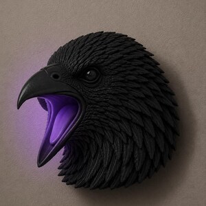 May include: A black raven head sculpture with an open beak, revealing a purple interior. The sculpture is mounted on a neutral-toned wall. The raven's feathers are detailed, and the eye is visible.