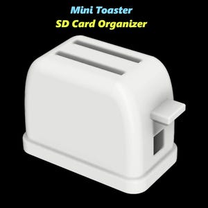 Puede incluir: Organizador de tarjetas SD en forma de mini tostadora de pl&aacute;stico blanco. El organizador tiene dos ranuras para tarjetas SD.