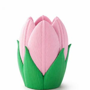 May include: A pink tulip-shaped ornament with green leaves at the base. The pink petals have a textured surface, and the green leaves provide a contrasting colour. The item is designed to resemble a tulip flower.