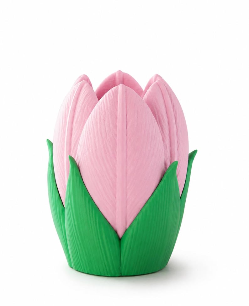 May include: A pink tulip-shaped ornament with green leaves at the base. The pink petals have a textured surface, and the green leaves provide a contrasting colour. The item is designed to resemble a tulip flower.