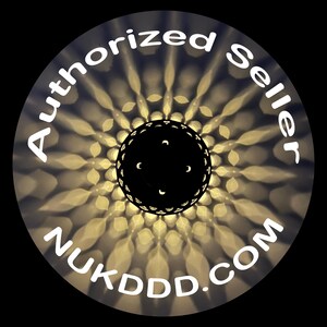 May include: Circular image with a black center and a decorative pattern of light and shadow. The words "Authorized Seller" and "NUKDDD.COM" are written in white around the edge of the circle.