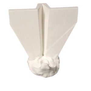 May include: A white, abstract sculpture with a geometric design. The sculpture has a V-shaped top with angled sides and a textured, cloud-like base. The piece is made of a solid, opaque material.