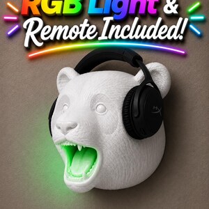 May include: White panda head wall mount with black headphones and a glowing green mouth. The text "RGB Light & Remote Included!" is displayed above the panda head in colorful letters.