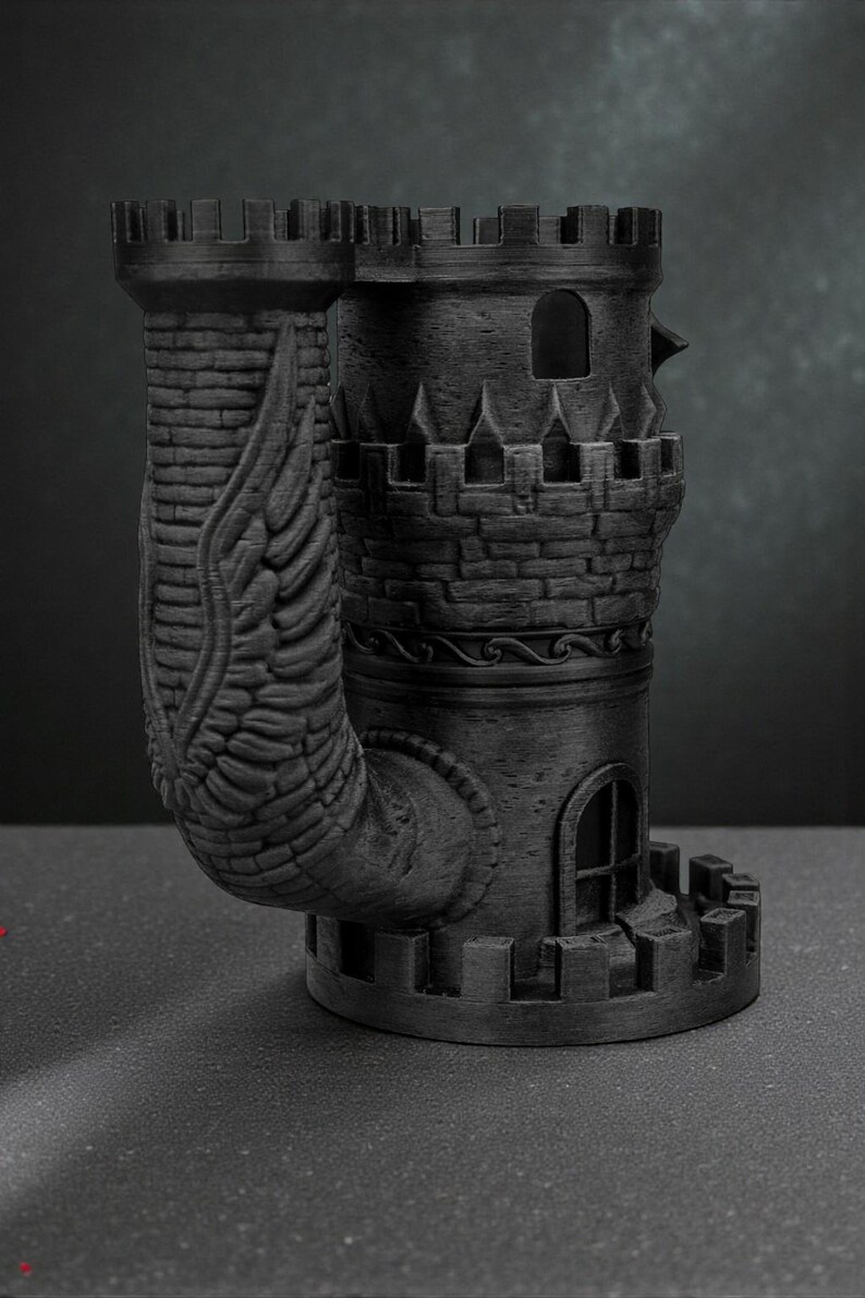 May include: A black, 3D-printed castle-shaped mug with a unique design. The mug features a tower with a crenelated top, arched windows, and a curved handle adorned with a wing motif. The mug is approximately 6 inches tall.