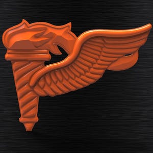 May include: An orange plastic winged torch with a textured surface. The torch is a symbol of the United States Army Air Forces.