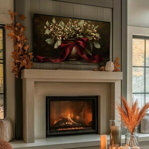 A vintage Christmas painting of mistletoe in a vase tied with a deep red bow. The artwork features warm golden and earthy tones, creating a moody, candle-lit atmosphere perfect for old-world Christmas décor. Ideal for Samsung Frame TV, this digital download adds elegance and nostalgia to any home, pairing beautifully with vintage, rustic, or dark academia holiday interiors.