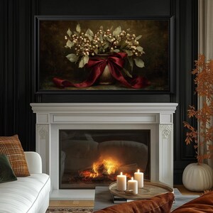 A vintage Christmas painting of mistletoe in a vase tied with a deep red bow. The artwork features warm golden and earthy tones, creating a moody, candle-lit atmosphere perfect for old-world Christmas décor. Ideal for Samsung Frame TV, this digital download adds elegance and nostalgia to any home, pairing beautifully with vintage, rustic, or dark academia holiday interiors.