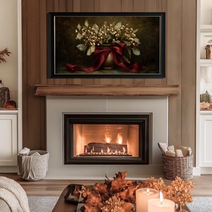 A vintage Christmas painting of mistletoe in a vase tied with a deep red bow. The artwork features warm golden and earthy tones, creating a moody, candle-lit atmosphere perfect for old-world Christmas décor. Ideal for Samsung Frame TV, this digital download adds elegance and nostalgia to any home, pairing beautifully with vintage, rustic, or dark academia holiday interiors.
