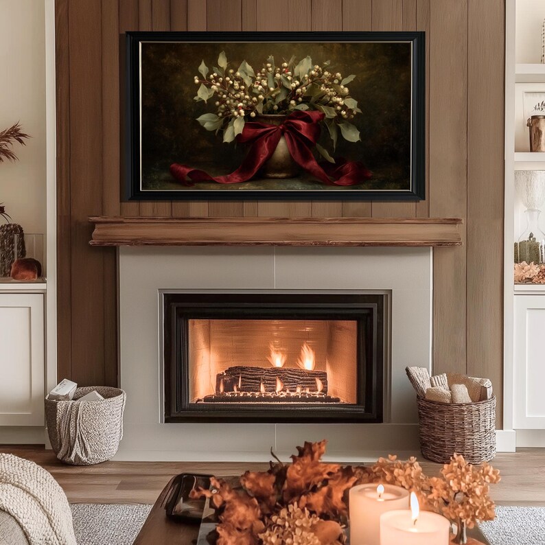 A vintage Christmas painting of mistletoe in a vase tied with a deep red bow. The artwork features warm golden and earthy tones, creating a moody, candle-lit atmosphere perfect for old-world Christmas décor. Ideal for Samsung Frame TV, this digital download adds elegance and nostalgia to any home, pairing beautifully with vintage, rustic, or dark academia holiday interiors.