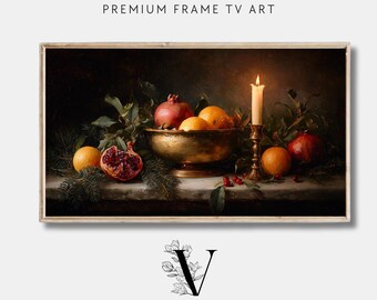 May include: A framed print of a still life painting featuring pomegranates, oranges, and a brass bowl. A lit candle sits in a brass holder. The text "PREMIUM FRAME TV ART" and "VINTAGE HEIRLOOM ART COLLECTIVE" are visible.
