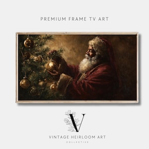 May include: A framed digital art print featuring Santa Claus decorating a Christmas tree with gold ornaments. The artwork has a vintage, painterly style with warm, inviting colors. Text at the top reads "PREMIUM FRAME TV ART" and at the bottom "VINTAGE HEIRLOOM ART COLLECTIVE."