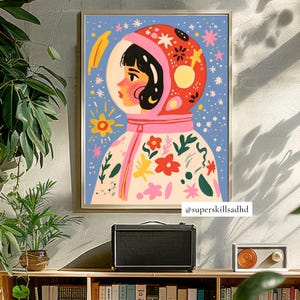 May include: A colorful illustration of a person wearing a pink and red astronaut suit with a floral pattern. The background is blue with white stars and other celestial elements. The image includes the text "@superskillsadhd".