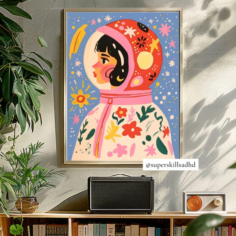 May include: A colorful illustration of a person wearing a pink and red astronaut suit with a floral pattern. The background is blue with white stars and other celestial elements. The image includes the text "@superskillsadhd".