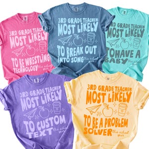 May include: A collection of five colorful t-shirts. Each shirt features the text "3rd Grade Teacher Most Likely" with a unique phrase below, such as "To Be Wrestling Technology" or "To Break Out Into Song". The shirts are in various colors.