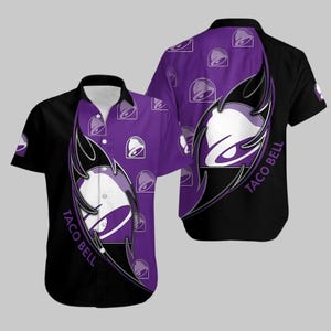 May include: Short-sleeved button-down shirt featuring a black and purple design with the Taco Bell logo. The shirt has a white collar and a repeating pattern of the Taco Bell bell logo on the purple sections. The shirt is a casual wear item.