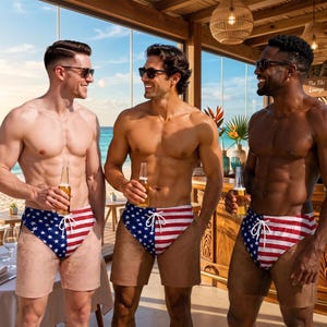 May include: Three individuals wearing swim trunks featuring a split design with a blue field of white stars on one side and red and white horizontal stripes on the other, each holding a glass bottle while standing in a beachside lounge setting.