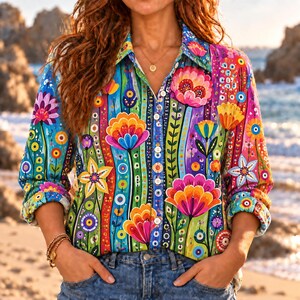 May include: A long-sleeve button-down shirt featuring a vibrant, multicoloured floral pattern with vertical stripes. The design includes large stylised flowers in shades of pink, orange, yellow, and blue against a green and blue background.