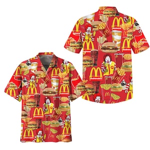 May include: Two short-sleeved button-down shirts with a red background and a repeating pattern of McDonald's food items and Ronald McDonald. The pattern includes burgers, fries, drinks, and the McDonald's logo.