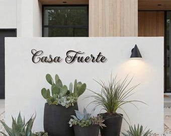 May include: A rustic wooden sign with the text "Welcome to our home" in white lettering. The sign features a distressed finish and a simple, inviting design, perfect for entryway decor.