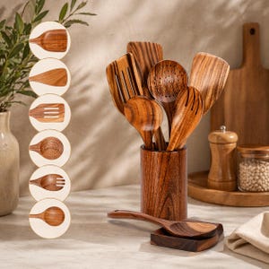 May include: A set of wooden kitchen utensils, including spoons, spatulas, and slotted tools, presented in a wooden holder. A spoon rest and a wooden chopping board are in the background. The utensils are made of light brown wood.