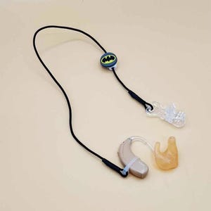 Black single retention cord for hearing aid or cochlear implant